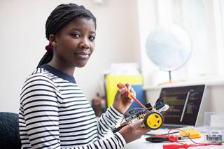 Female student engaging in robotics