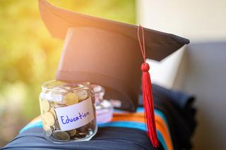 Graduation cap and top of a jar of money