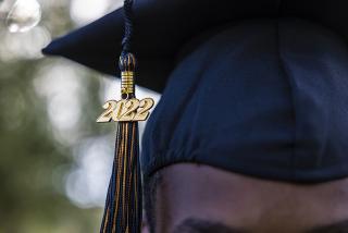 A close up of a man wearing a class of 2022 graduation cap
