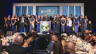 President Jenkins is joined on stage by Coppin State University students during the 2nd Annual Gala,