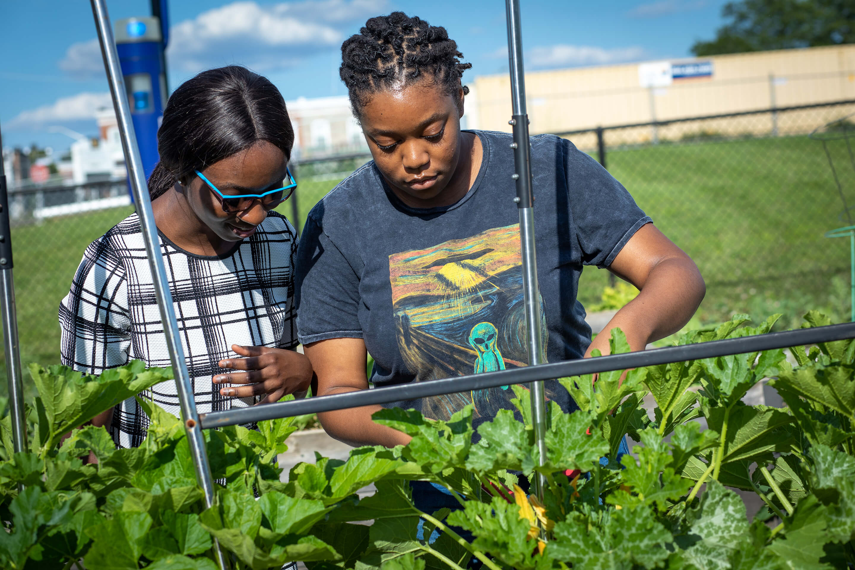 two students in the community garden