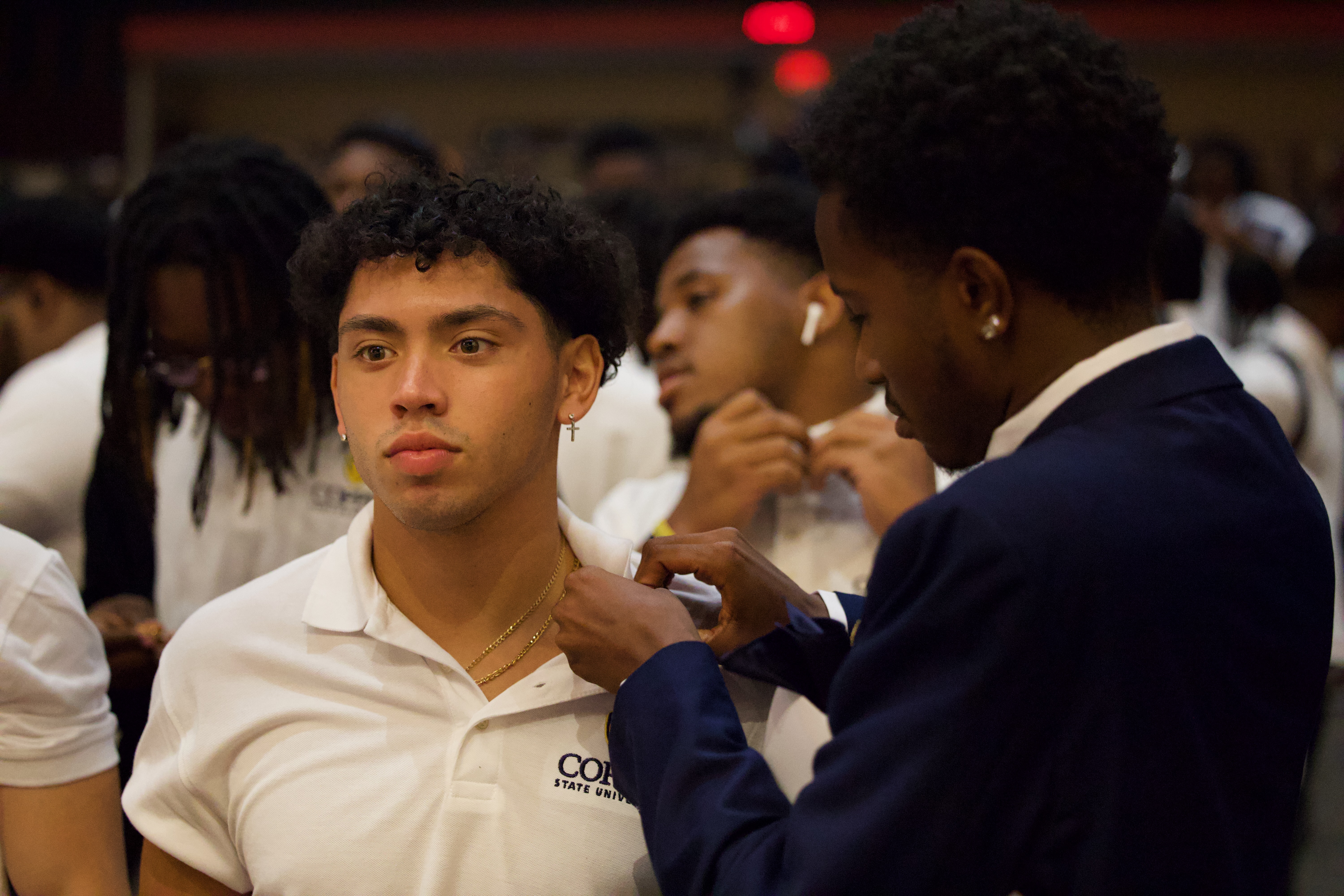 Mister Coppin pinning an incoming freshman during 2023 Convocation