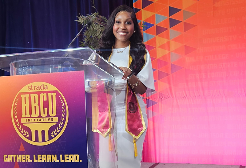 Janiya Camphor, Health Information Systems major, celebrates becoming the first graduate of the Coppin Strada Program at Coppin State University in May 2026.
