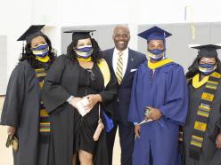 Dr. Jenkins photo with graduating students at commencement