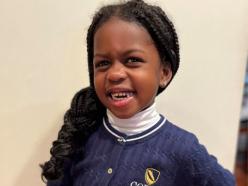 Photo of young girl wearing a coppin sweatshirt