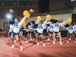 Cheerleaders striking pose in Be More swag