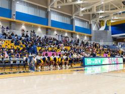 Coppin State University students, cheerleaders, and supporters gather in the Physical Education Complex for Eagle Madness 2026, filling the blue and gold bleachers with Eagle pride and school spirit.