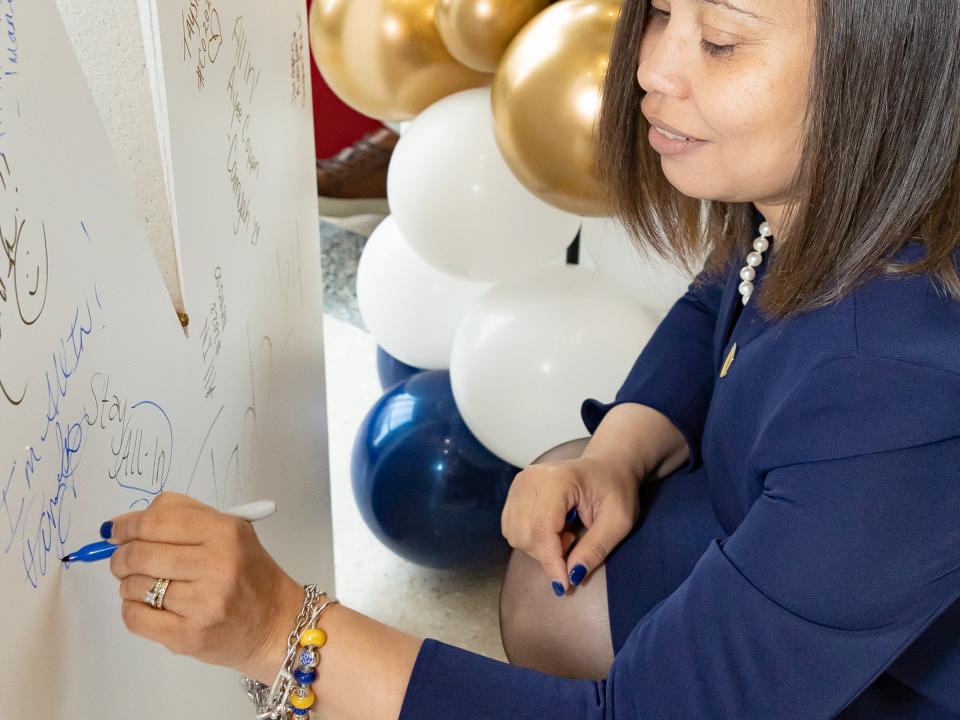 Provost Wilkes signs 'IN.'