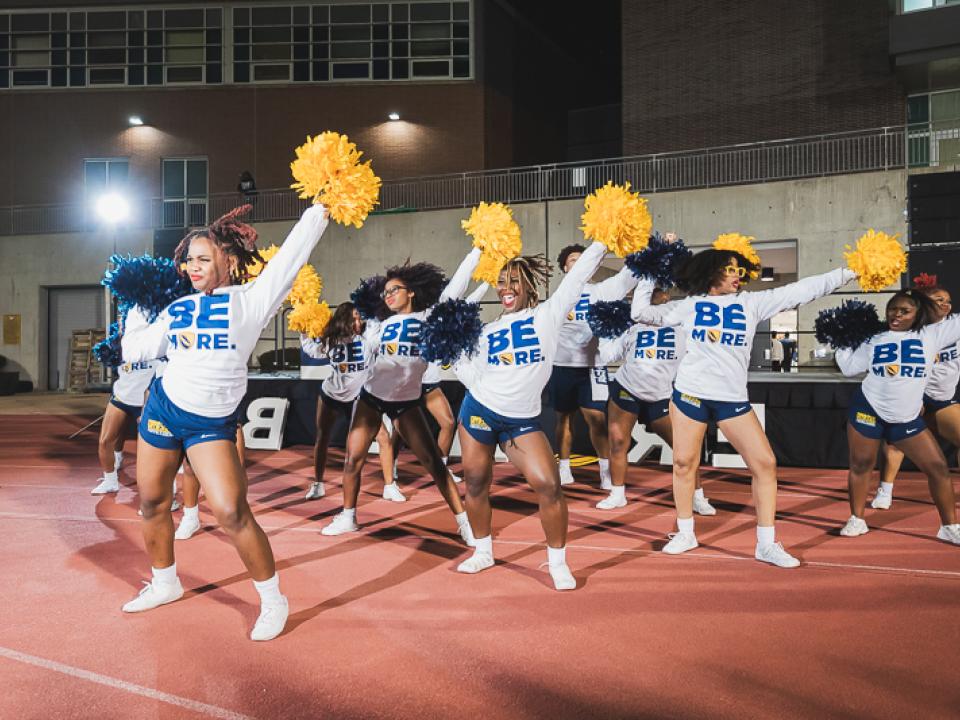 Cheerleaders striking pose in Be More swag