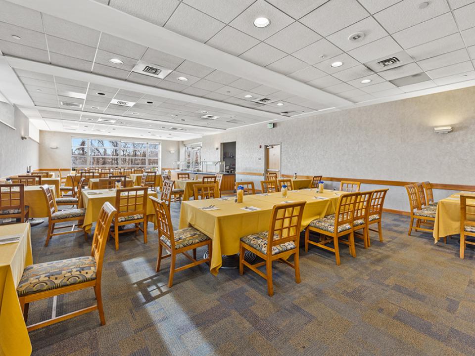 The Café features tables with seating, a buffet, and outdoor seating.