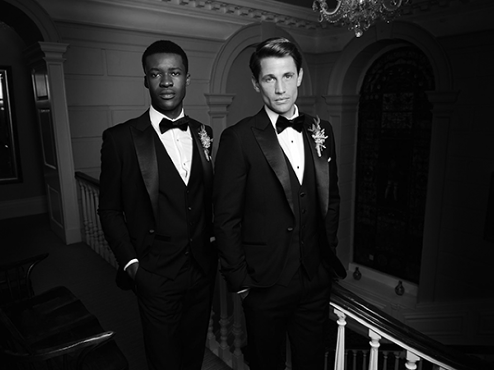 Two men in formal tuxedos.