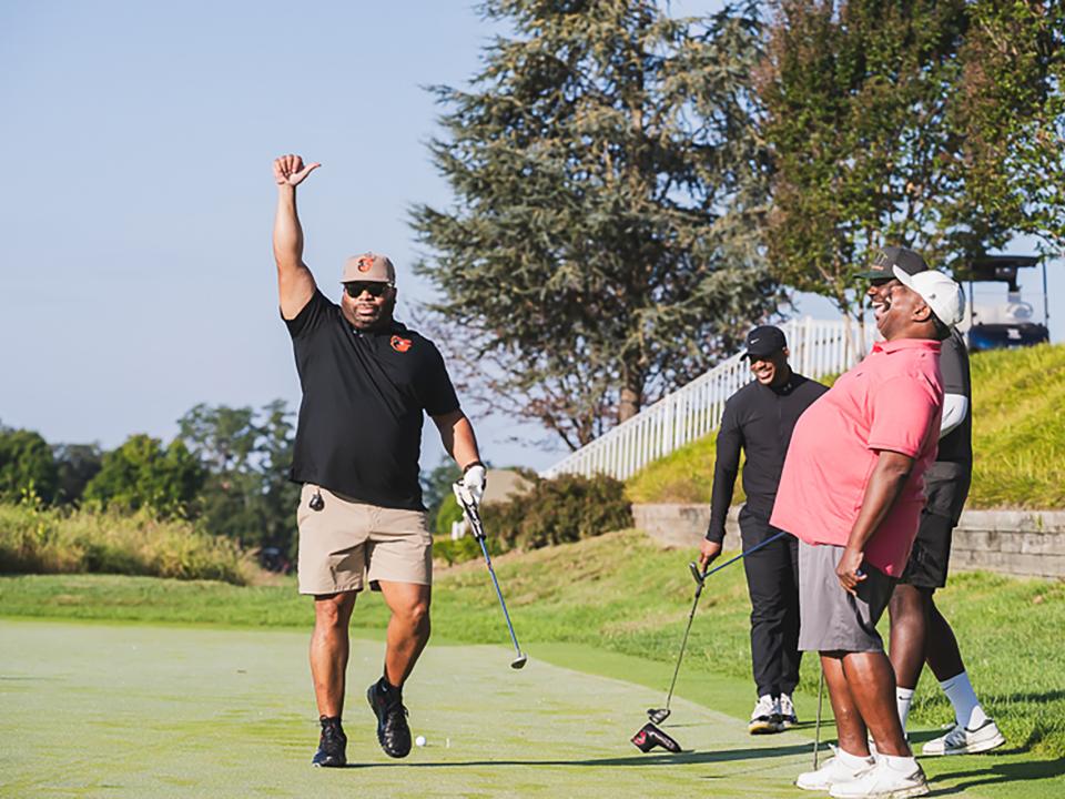 Golfer holding hand up at Coppin Golf Classic.