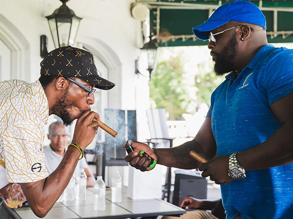Cigar being lit during Coppin Golf Classic.