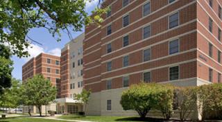 Red brick exterior of Flossie Dedmond Residence Hall on Coppin State University campus.