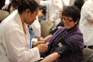 nurse with woman getting blood pressure taken