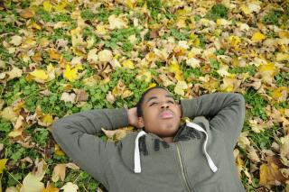 man laying in leaves