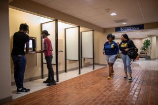 Students registering for class in the administration building