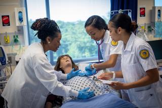 Nursing students learning skills in the simulation lab