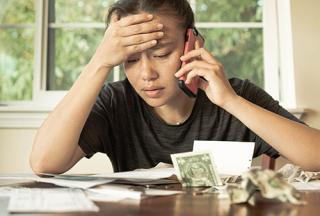 student siting around a table with money on it