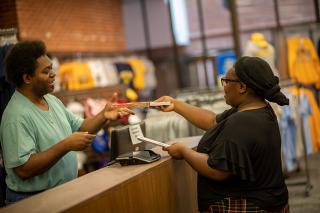 A student shopping for books in the campus bookstore