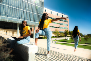 Coppin State Open House Fall 2021. A young lady replicated across campus.