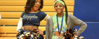 Coppin State cheerleader bonding with a young girl