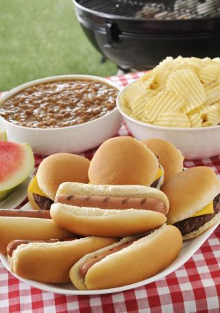 Tailgate Grilling out - Cheeseburgers and hotdogs with a variety of side items.
