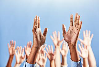 Group of raised open hands