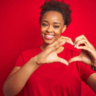 woman doing heart symbol shape with hands