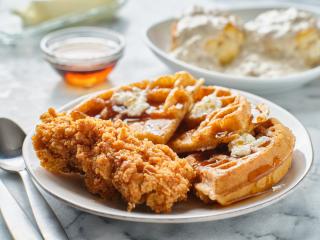 fried chicken and waffles breakfast with maple syrup