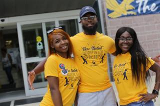 Three student volunteers for move in