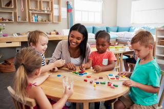 A dedicated teacher teaching kindergarteners