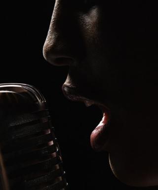 Person speaking into a microphone