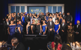 Dr. Jenkins with students on stage at the 2024 Gala