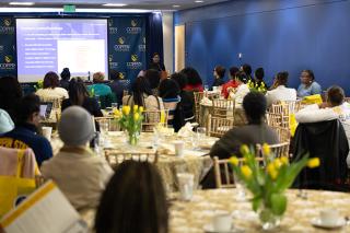 Audience listens during the morning keynote delivered by Secretary Tisha Edwards during the 2025 Women's History Month Forum
