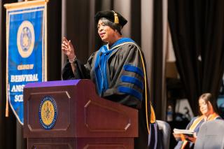 Provost Haywood speaks on stage at Convocation
