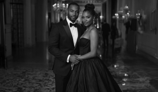 A couple dressed in black tuxedo and ball gown