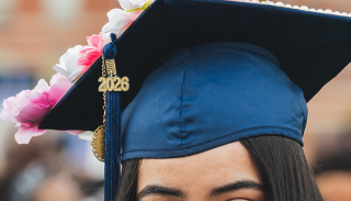 Close up of a decorated blue cap and tassel worn by a student at commencement