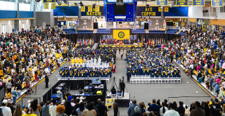 Wide angle photo of 2026 Coppin commencement in the PEC Arena.
