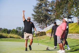 Golfer holding hand up at Coppin Golf Classic.