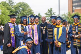 Dr. Jenkins with Male Grads at Commencement 2024