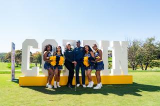 Cheerleaders with Dr. Jenkins at Golf Classic 